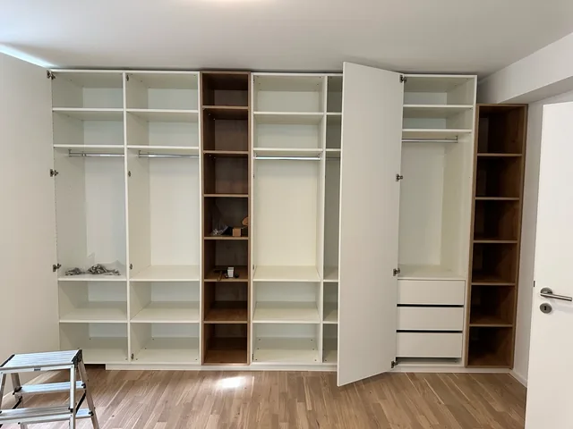 Schrankwand mit offenen Regalen, Kleiderstangen und Schubladen