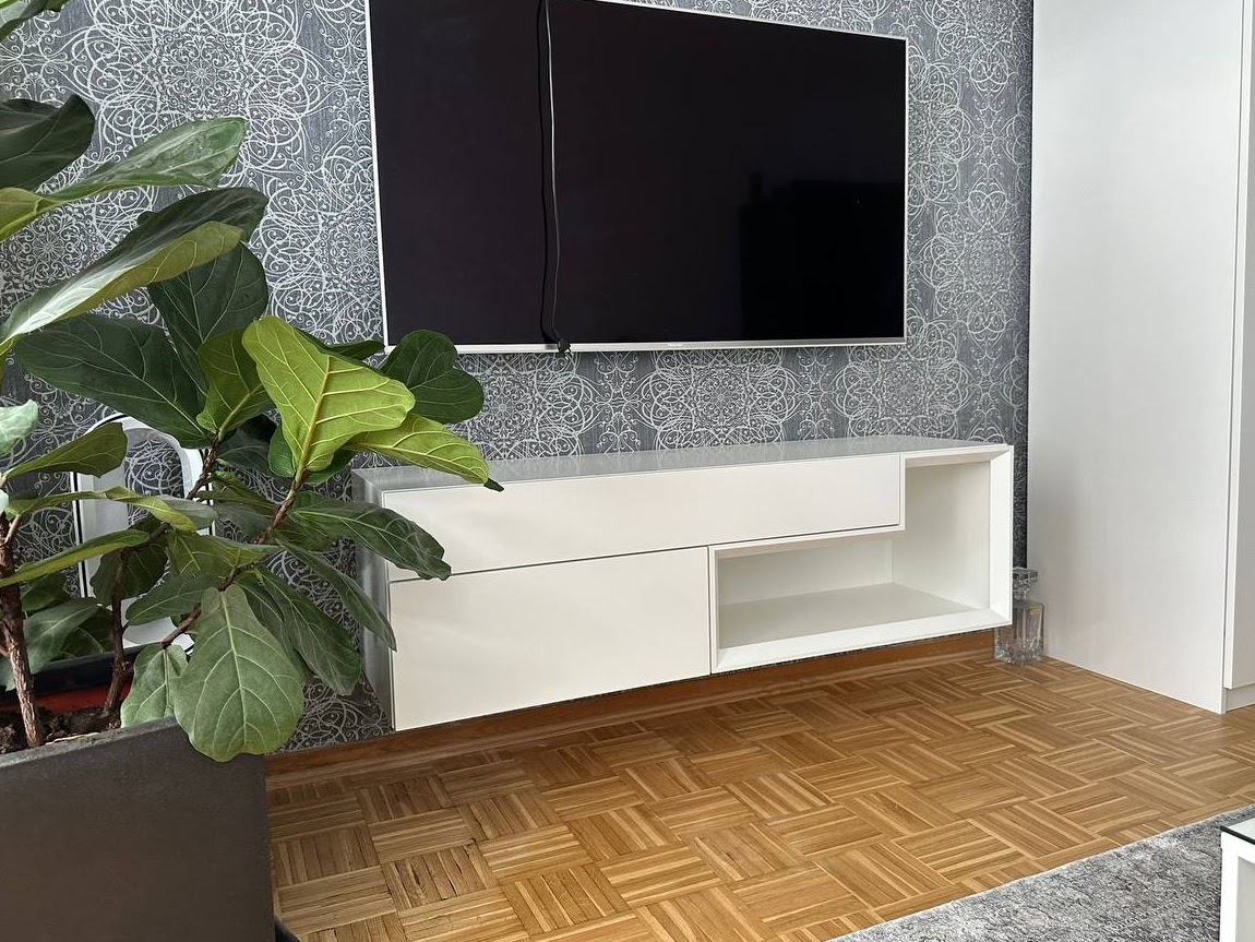 Fertiges weißes TV-Möbel an einer Wohnzimmerwand